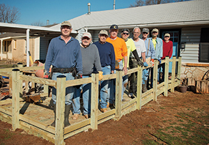 The A-Team stands with a completed wheelchair ramp