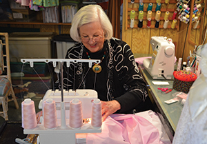 Volunteer Barbara Byrd sews a dress for U R Special