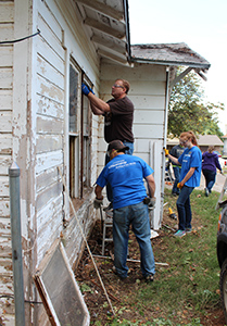 Team members from Boeing work on a house in OKC
